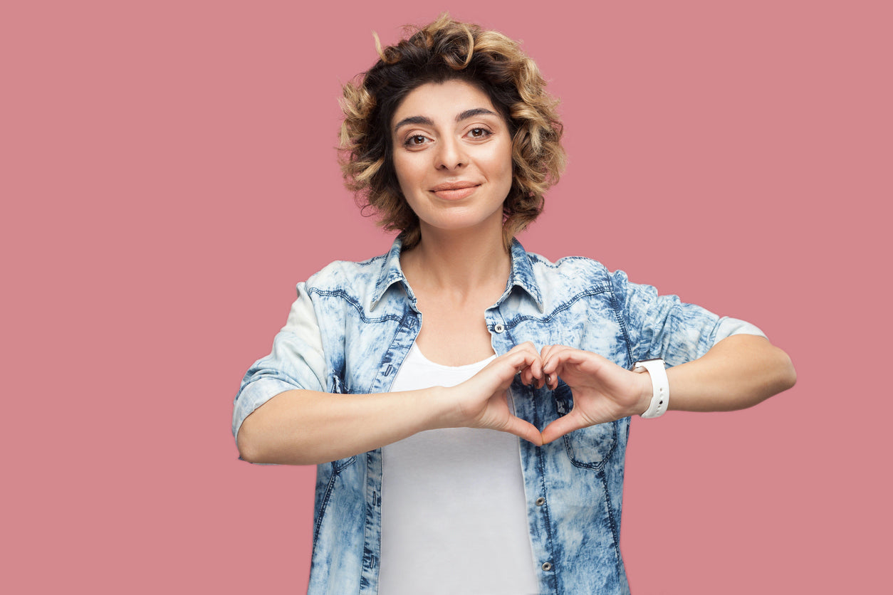 woman making heart sign with her hands