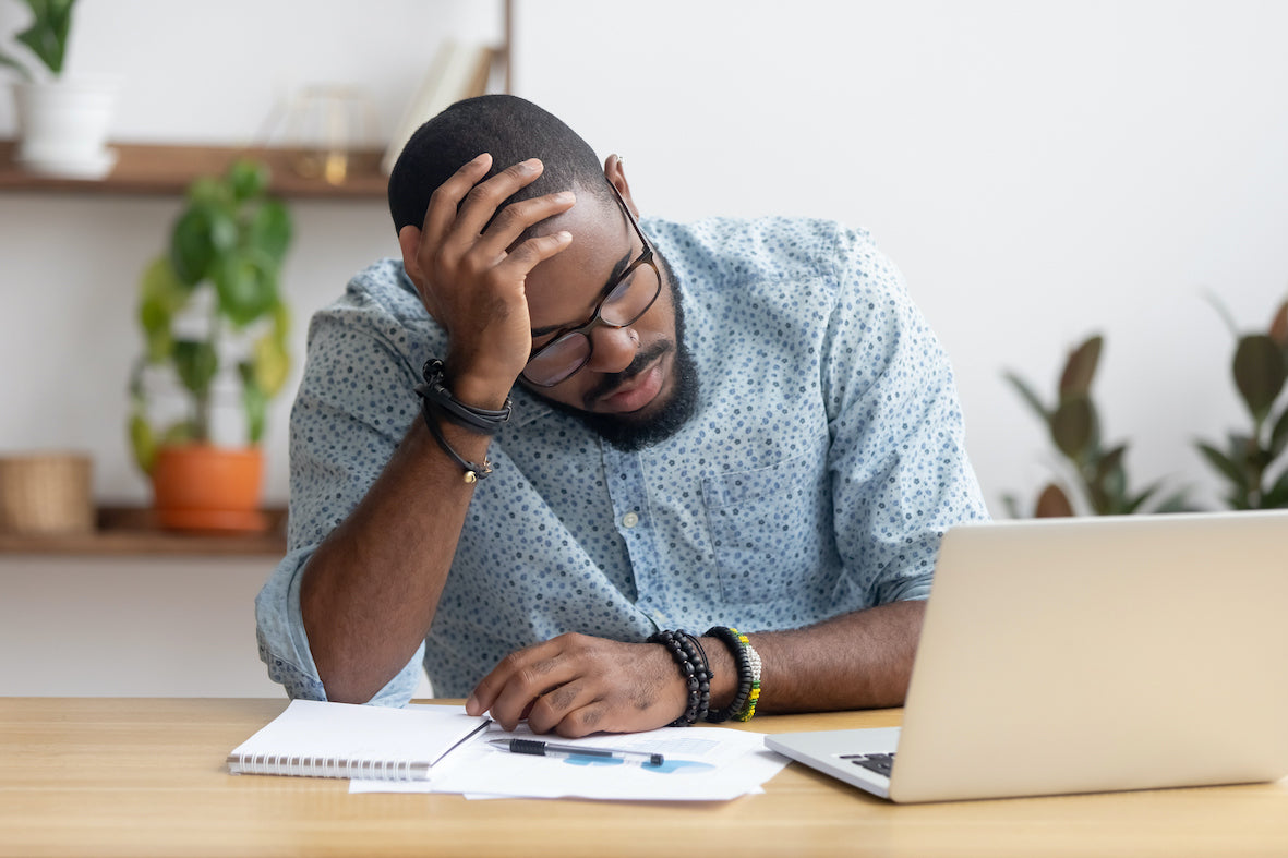 sleep deprived man working on his computer