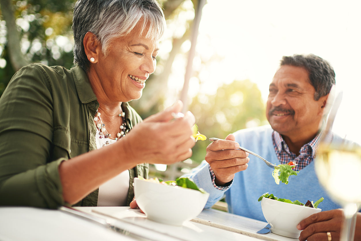 Latino woman and man eating salad