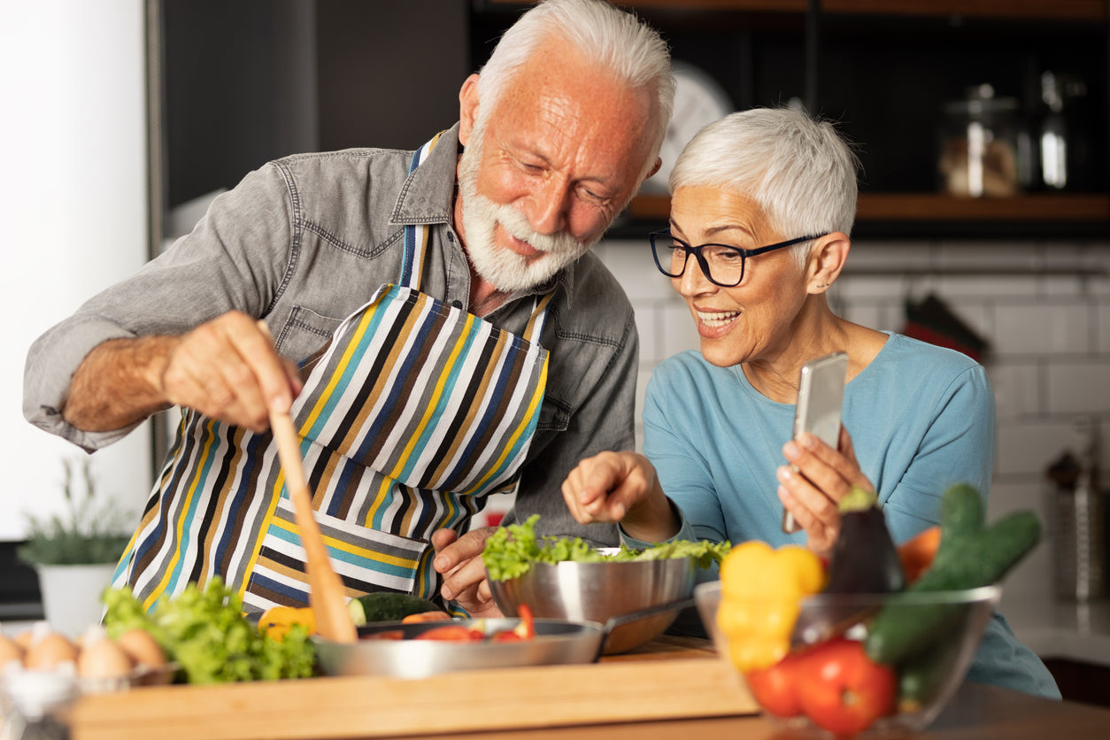 Senior people cooking health food together 